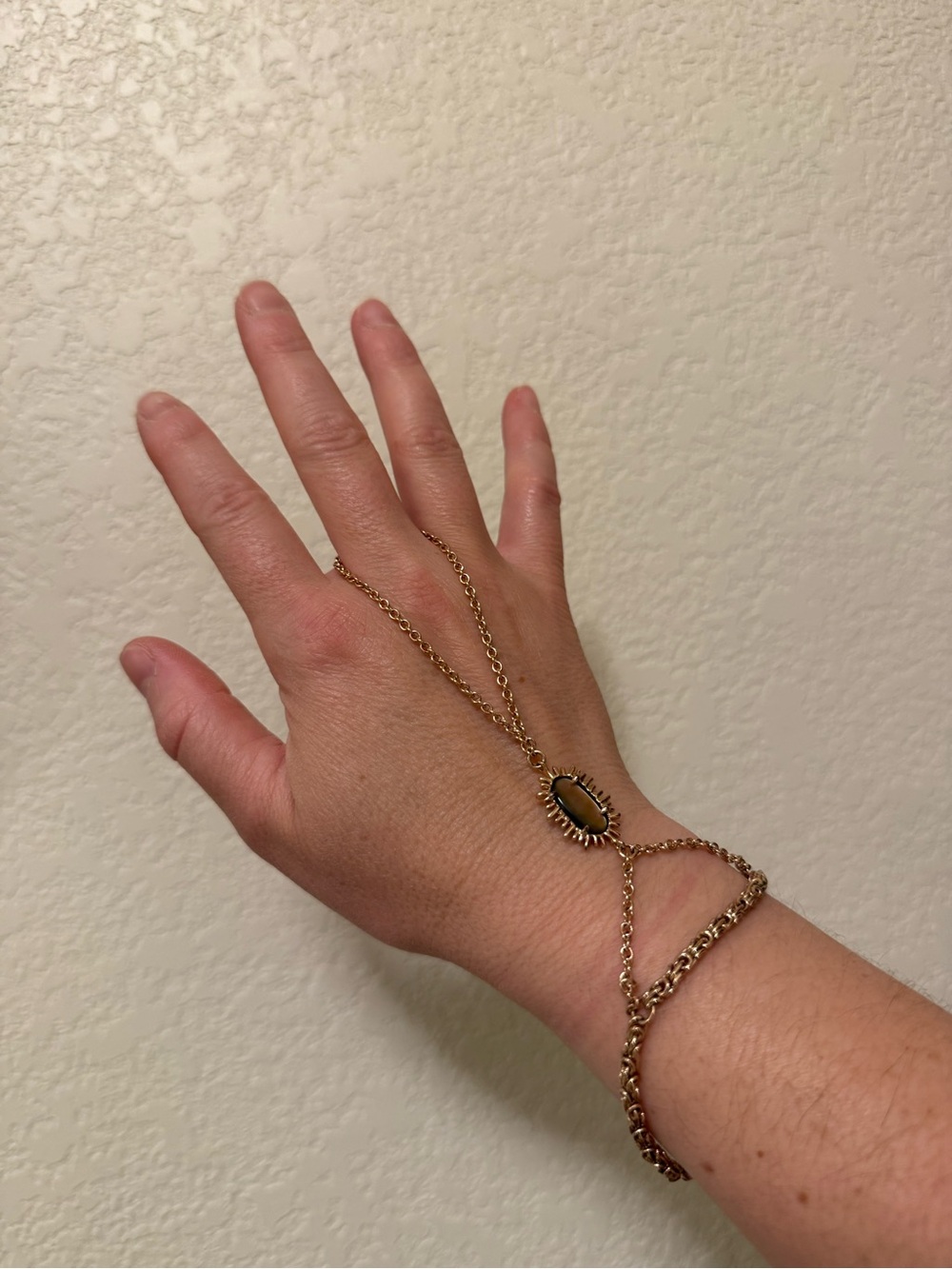 Kendra Scott Gold-Tone Hand Chain Bracelet with stone.